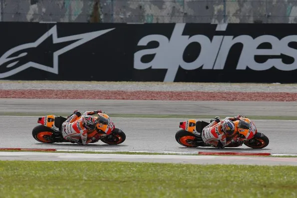 Marc Márquez and Dani Pedrosa, riding their Repsol Honda's at the 2013 Malaysian Grand Prix.