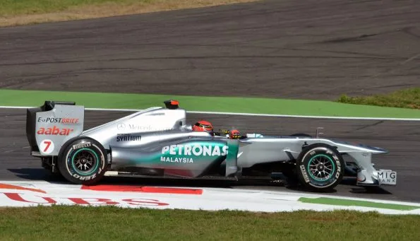 Michael Schumacher riding the kerbs at Rettifilo in his Mercedes MGP W02 during first practice for the 2011 Italian Grand Prix at Monza.