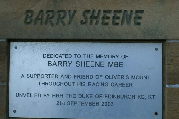 Barry Sheene MBE memorial plaque at Oliver's Mount circuit, featuring his name in raised lettering.
