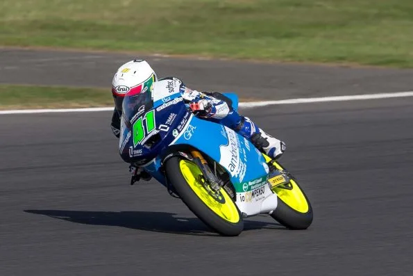 Brad Binder, number 41, cornering his blue and white Ambrogio Racing Moto3 machine during practice at the 2013 British Grand Prix at Silverstone.