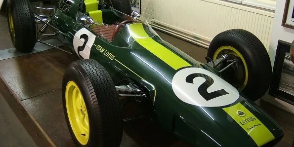Lotus 25 Formula One car in British racing green with a yellow stripe, Team Lotus markings