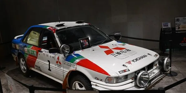 Mitsubishi Galant VR-4 rally car in white Ralliart livery with roof-mounted lamps