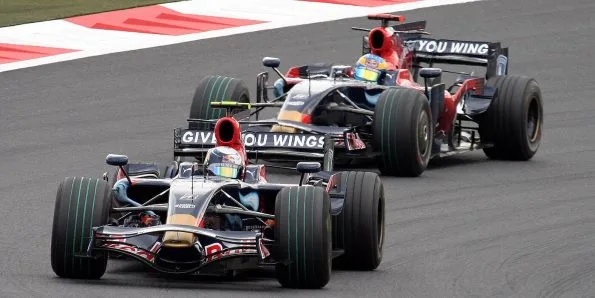 Two Toro Rosso STR3 cars in red and blue livery running together in 2008