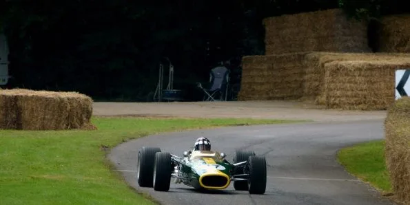 Lotus 49 Formula One car in green and yellow running at the Goodwood Festival of Speed