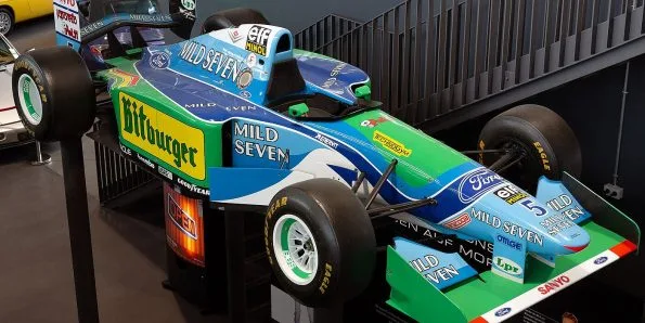 Benetton B194 in green, blue and yellow Mild Seven livery, front three-quarter view