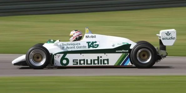 A 1982 Williams FW08 in Saudia colours photographed side-on on track