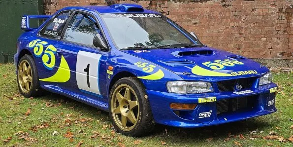Subaru Impreza World Rally Car in blue and yellow 555 livery with gold wheels