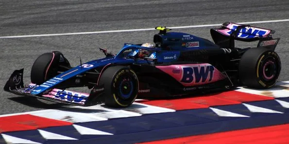Pierre Gasly driving the Alpine A523 in blue and pink at the 2023 Austrian Grand Prix