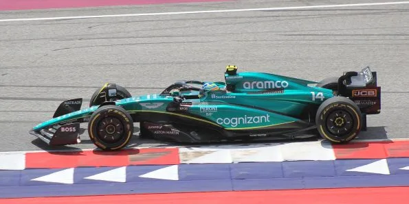 Fernando Alonso driving the Aston Martin AMR23 in green at the 2023 Austrian Grand Prix