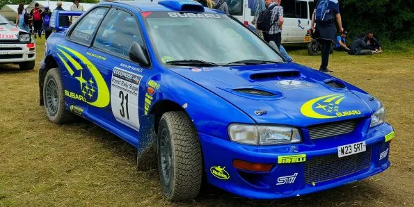 Subaru Impreza World Rally Car in the team's blue and yellow star livery