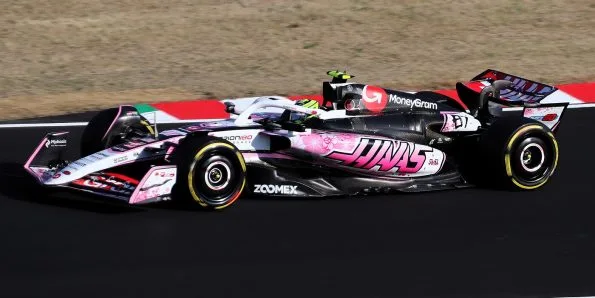 Oliver Bearman driving the Haas VF-25 in black and pink at the 2025 Japanese Grand Prix
