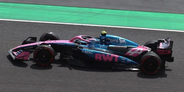 Jack Doohan driving the Alpine A525 in blue and pink at the 2025 Japanese Grand Prix
