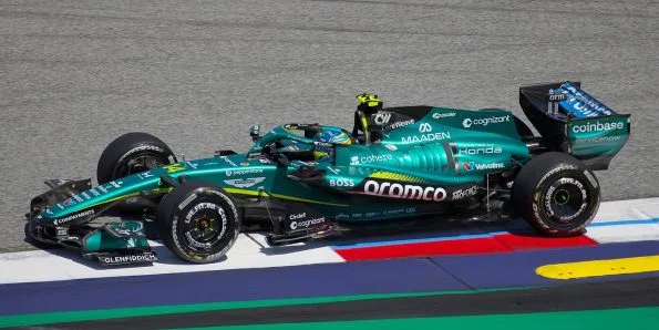Fernando Alonso driving the Aston Martin AMR26 in green at the 2026 Austrian Grand Prix
