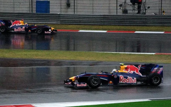 wo Red Bull racing cars competing on a wet track at the 2009 Chinese Grand Prix