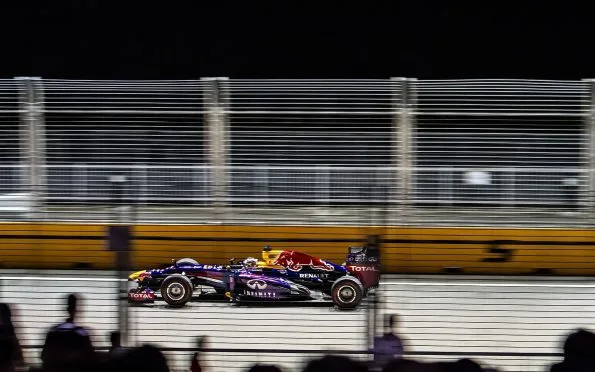 Red Bull Racing Formula 1 car racing under lights during the 2013 season