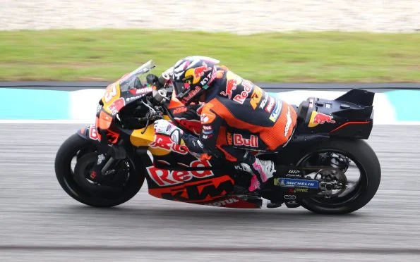 Red Bull KTM Tech3 racing bike in the premier class featuring the iconic black and green livery during the Yamaha era.