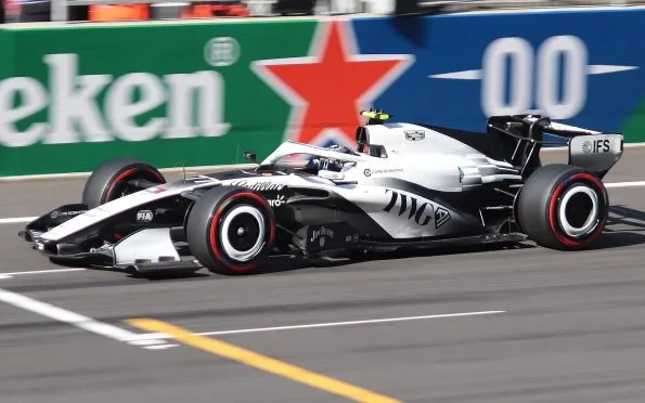 Cadillac MAC-26 race car with drivers Sergio Perez and Valtteri Bottas competing in Formula 1