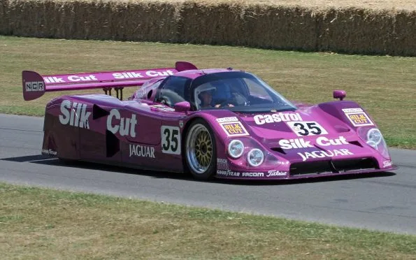 Silk Cut Jaguar XJR-12 number 35 in purple livery running at a historic motorsport meeting