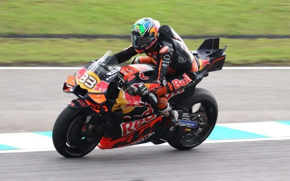 Red Bull KTM Factory Racing rider accelerating through a corner on the RC16 bike during a Grand Prix weekend.