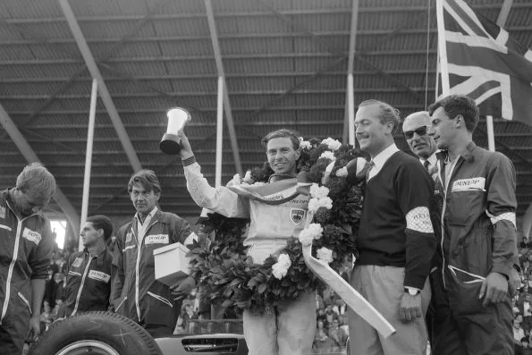 Jim Clark holding the trophy and wearing the winners wreath after the 1963 Dutch Grand Prix at Zandvoort
