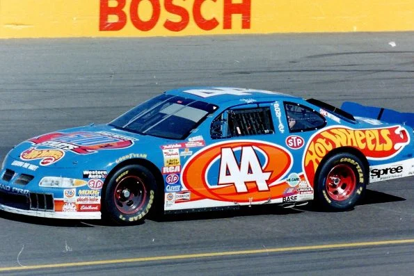 Kyle Petty driving the blue number 44 Hot Wheels PE2 Pontiac on track at Phoenix International Raceway.
