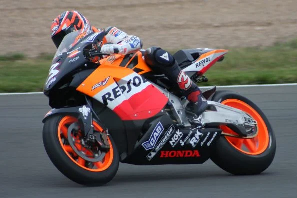 Max Biaggi leaned into a corner on the orange, white and red Repsol Honda, number 3.