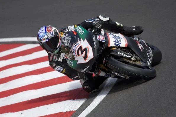 Max Biaggi cranked over across the kerbs on the black Sterilgarda Ducati, number 3.