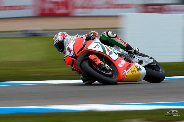 Max Biaggi on the red and green Aprilia RSV4 carrying the number 1 of the reigning champion.