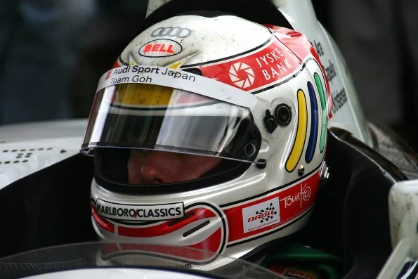 Tom Kristensen in his helmet in the cockpit of the Audi R8 in the pits at Le Mans in 2004