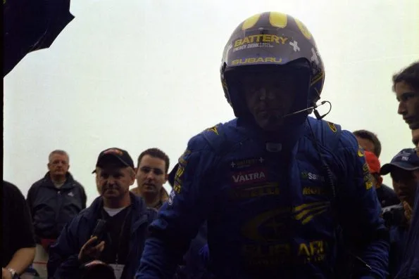 Tommi Mäkinen in Subaru overalls and helmet during Rallye Deutschland in 2002