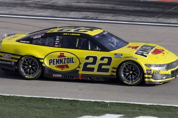 Joey Logano's yellow No. 22 Pennzoil Ford on track at Las Vegas Motor Speedway in 2024, his third championship season.