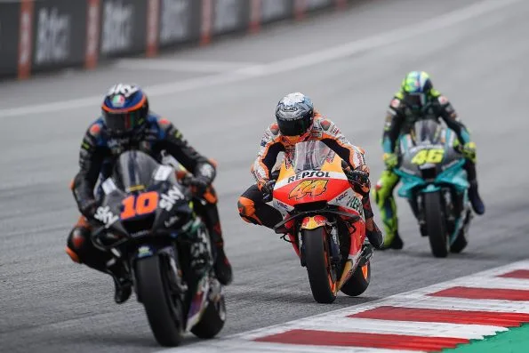 Luca Marini riding the number 10 Sky VR46 Ducati on track at Spielberg in 2021, alongside Pol Espargaró on the number 44 Repsol Honda and Valentino Rossi on the number 46 Petronas