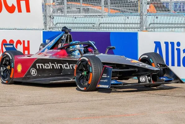 Lucas di Grassi's dark red Mahindra Racing Formula E car on track at the 2023 Berlin E-Prix.