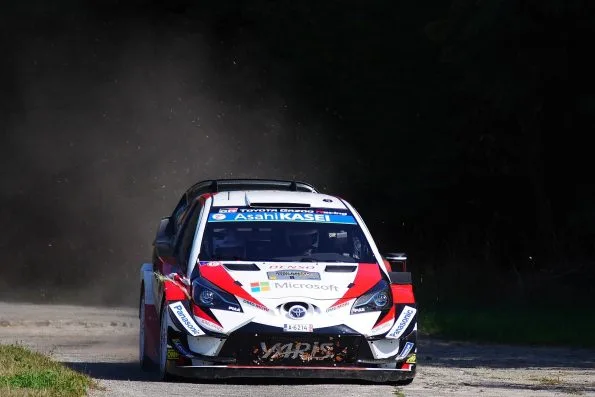 Ott Tänak's Toyota Yaris WRC, car 8, head-on out of a dust cloud on the Panzerplatte stage at Rallye Deutschland in 2018, straw debris caught in the front bumper after clipping a bale.